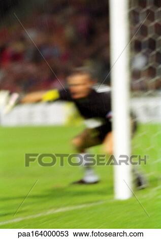 Goal keeper defending goal in soccer match, blurred. View Large Photo Image Stock Image - Goal keeper defending goal in soccer match, blurred.. Fotosearch