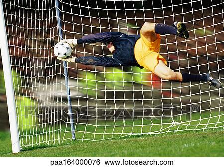 Goal keeper, horizontal, saving ball during match, full length View Large Photo Image Stock Photograph - Goal keeper, horizontal, saving ball during match, full length. Fotosearch