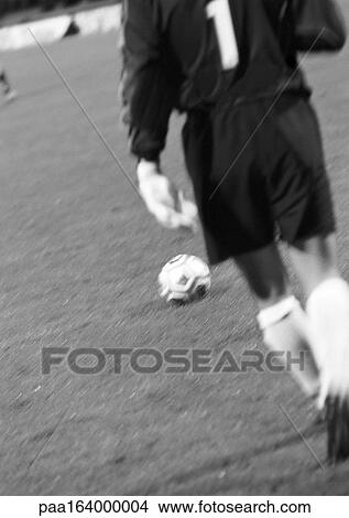 Picture - Goal keeper in soccer match, rear view, blurred, b&w.. Fotosearch