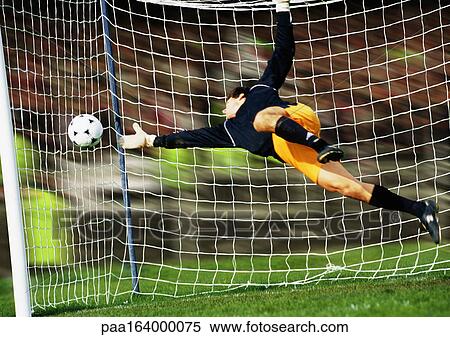 Goal keeper reaching for soccer ball. View Large Photo Image Stock Photography - Goal keeper reaching for soccer ball.. Fotosearch