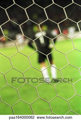 Goal keeper, rear view, blurred, seen from behind the net. View Large Photo Image Stock Image - Goal keeper, rear view, blurred, seen from behind the net.. Fotosearch