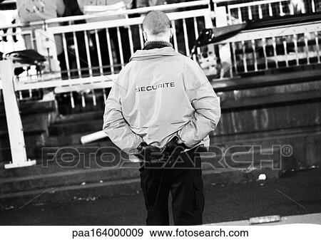 Security guard at soccer match, rear view, b&w. View Large Photo Image Stock Photo - Security guard at soccer match, rear view, b&w.. Fotosearch