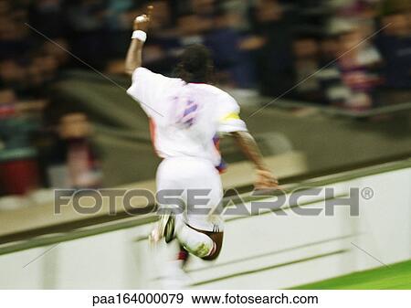 Soccer player running, hand up, rear view. View Large Photo Image Stock Photo - Soccer player running, hand up, rear view.. Fotosearch