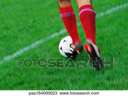 Soccer player running with ball, low section. View Large Photo Image Stock Image - Soccer player running with ball, low section.. Fotosearch