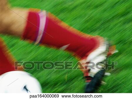 Soccer player running with ball, low section, close-up, blurred. View Large Photo Image Stock Photo - Soccer player running with ball, low section, close-up, blurred.. Fotosearch