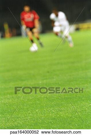 Soccer player running with ball, opponent chasing him, blurred. View Large Photo Image Stock Image - Soccer player running with ball, opponent chasing him, blurred.. Fotosearch