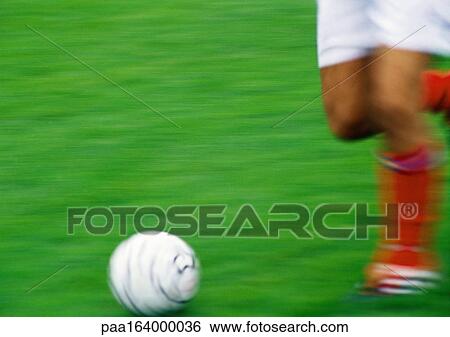Soccer player running with ball, blurred, low section. View Large Photo Image Stock Photograph - Soccer player running with ball, blurred, low section.. Fotosearch