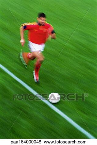 Soccer player running with ball, blurred. View Large Photo Image Stock Photography - Soccer player running with ball, blurred.. Fotosearch