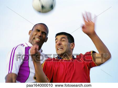 Two players competing for the ball during a soccer match, blurred, portrait. View Large Photo Image Stock Image - Two players competing for the ball during a soccer match, blurred, portrait.. Fotosearch