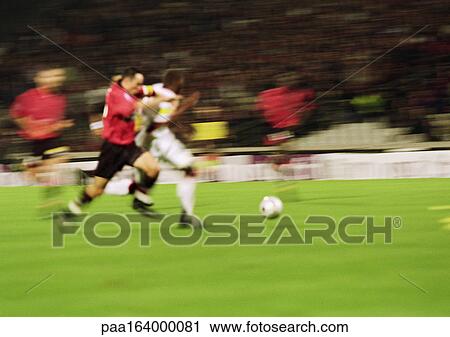 Two soccer players running for ball, blurred. View Large Photo Image Stock Image - Two soccer players running for ball, blurred.. Fotosearch