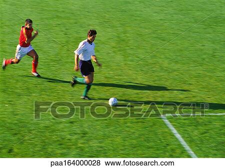 Two soccer players running for ball. View Large Photo Image Stock Photo - Two soccer players running for ball.. Fotosearch