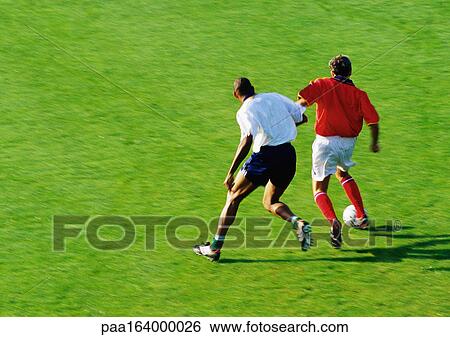 Two soccer players running for ball, full length View Large Photo Image Stock Photograph - Two soccer players running for ball, full length. Fotosearch