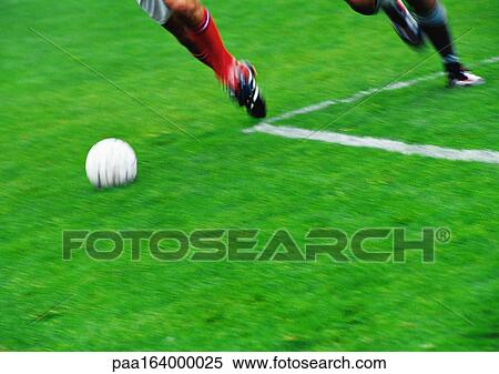 Two soccer players running for ball, blurred, low section. View Large Photo Image Stock Photography - Two soccer players running for ball, blurred, low section.. Fotosearch