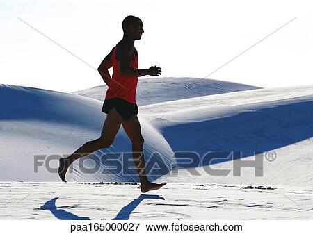 Barefooted man, running across dune, side view. View Large Photo Image Stock Photo - Barefooted man, running across dune, side view.. Fotosearch