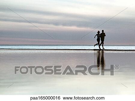 Couple running on beach. View Large Photo Image Stock Photograph - Couple running on beach.. Fotosearch