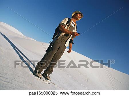 Hiker standing on dune View Large Photo Image Stock Photography - Hiker standing on dune. Fotosearch