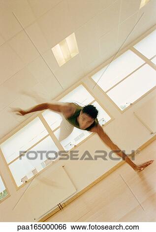 Stock Photograph - Man performing capoeira. Fotosearch