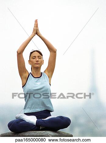 Paris, France, woman sitting in yoga position, Eiffel tower in background. View Large Photo Image Stock Image - Paris, France, woman sitting in yoga position, Eiffel tower in background.. Fotosearch