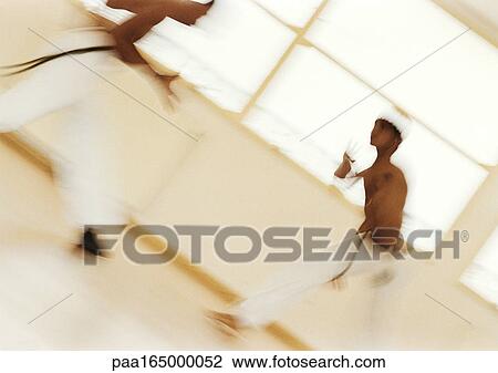 Two men performing capoeira, blurred View Large Photo Image Stock Image - Two men performing capoeira, blurred. Fotosearch