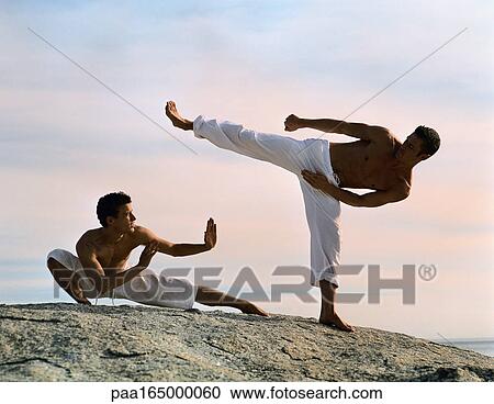 Two men performing martial arts, one defending, one attacking. View Large Photo Image Stock Image - Two men performing martial arts, one defending, one attacking.. Fotosearch