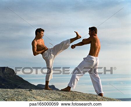 Two men performing martial arts, one defending, one attacking. View Large Photo Image Stock Photo - Two men performing martial arts, one defending, one attacking.. Fotosearch
