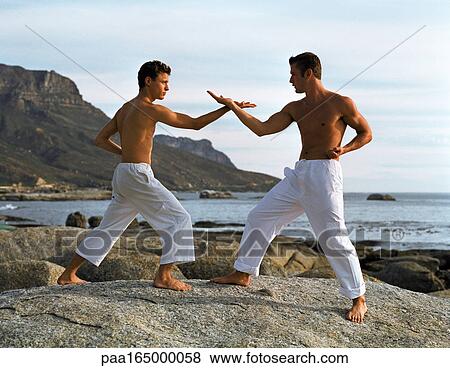 Two men performing martial arts, side view. View Large Photo Image Stock Photo - Two men performing martial arts, side view.. Fotosearch