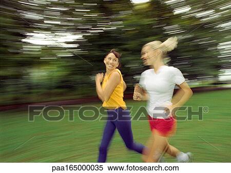 Two women running, blurred. View Large Photo Image Stock Photography - Two women running, blurred.. Fotosearch