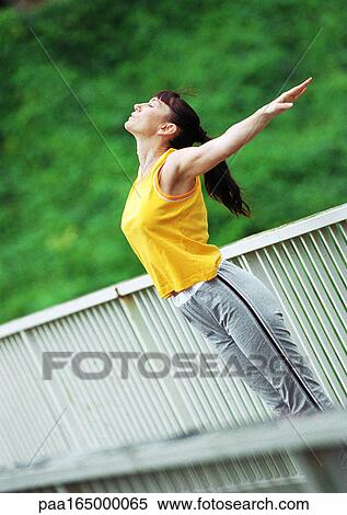 Woman doing stretching exercises on bridge, tilt. View Large Photo Image Stock Photography - Woman doing stretching exercises on bridge, tilt.. Fotosearch