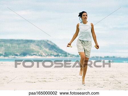 Woman jumping rope on beach. View Large Photo Image Stock Image - Woman jumping rope on beach.. Fotosearch