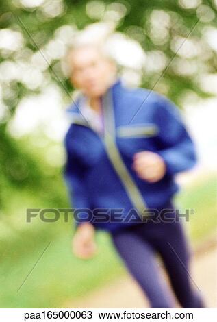 Stock Image - Woman running, blurred.. Fotosearch