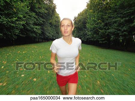 Picture - Woman running, front view. Fotosearch