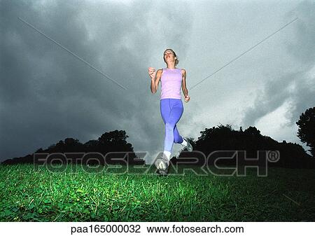 Woman running, low angle view View Large Photo Image Stock Image - Woman running, low angle view. Fotosearch