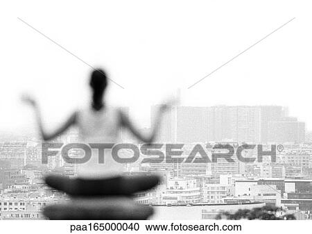 Woman sitting in yoga position, overlooking city, rear view, blurred, focus on background, b&w View Large Photo Image Stock Image - Woman sitting in yoga position, overlooking city, rear view, blurred, focus on background, b&w. Fotosearch