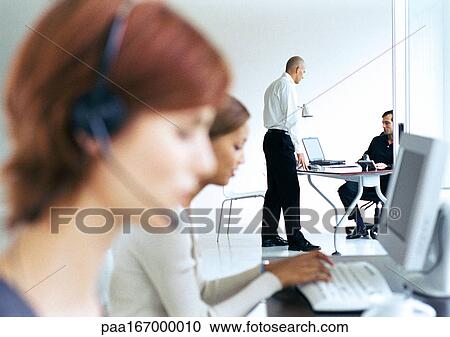 Business people in office, blurred foreground View Large Photo Image Stock Image - Business people in office, blurred foreground. Fotosearch