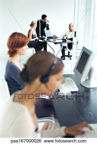 Business people in office, blurred foreground View Large Photo Image Stock Photograph - Business people in office, blurred foreground. Fotosearch