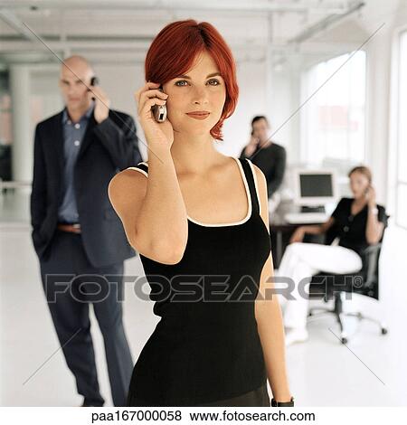Business people using cell phones in office, portrait View Large Photo Image Stock Photo - Business people using cell phones in office, portrait. Fotosearch