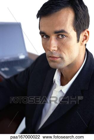 Businessman looking into camera, portrait View Large Photo Image Stock Image - Businessman looking into camera, portrait. Fotosearch