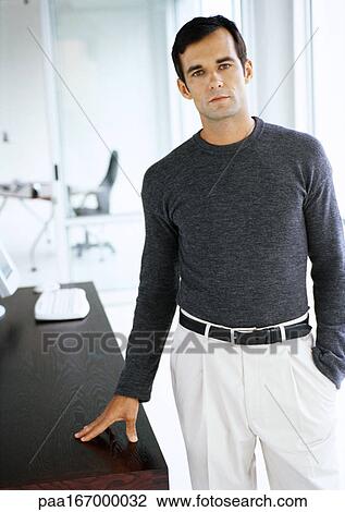 Businessman standing with hand on table View Large Photo Image Stock Image - Businessman standing with hand on table. Fotosearch