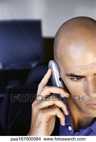 Businessman using cell phone, partial view of face, portrait, close-up View Large Photo Image Picture - Businessman using cell phone, partial view of face, portrait, close-up. Fotosearch