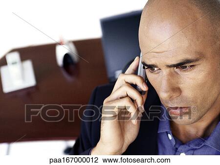 Stock Image - Businessman using cell phone. Fotosearch