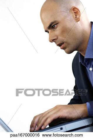 Businessman using laptop computer, side view View Large Photo Image Stock Photograph - Businessman using laptop computer, side view. Fotosearch