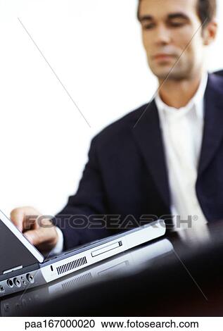 Businessman using laptop computer View Large Photo Image Stock Image - Businessman using laptop computer. Fotosearch