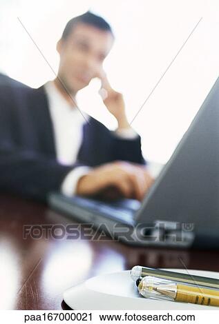 Businessman using laptop computer, blurred View Large Photo Image Stock Image - Businessman using laptop computer, blurred. Fotosearch