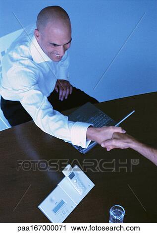 Businessmen shaking hands, elevated view View Large Photo Image Stock Image - Businessmen shaking hands, elevated view. Fotosearch