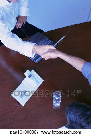 Handshake above desk View Large Photo Image Stock Photo - Handshake above desk. Fotosearch