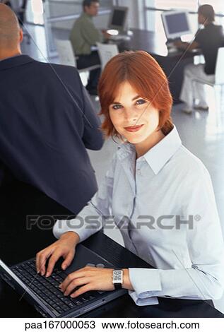 People working in office, businesswoman using laptop computer, portrait View Large Photo Image Stock Image - People working in office, businesswoman using laptop computer, portrait. Fotosearch