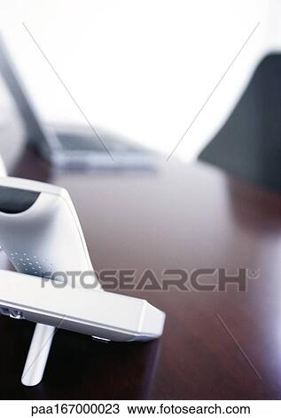 Stock Image - Telephone on desk, close-up. Fotosearch