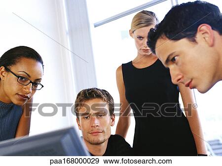 Stock Photo - Business people looking at computer. Fotosearch