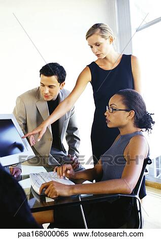 Business people looking at computer screen View Large Photo Image Stock Photography - Business people looking at computer screen. Fotosearch