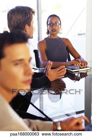 Business people sitting at table View Large Photo Image Stock Image - Business people sitting at table. Fotosearch
